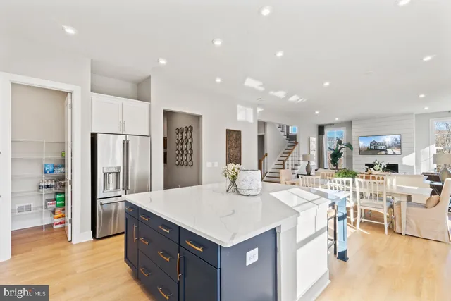 a kitchen with stainless steel appliances kitchen island granite countertop a refrigerator and a stove