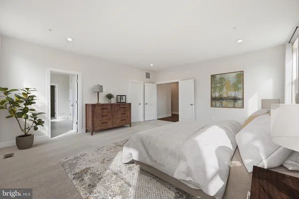 a spacious bedroom with a bed and a couch