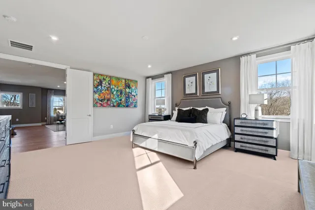 a spacious bedroom with a bed and a large window