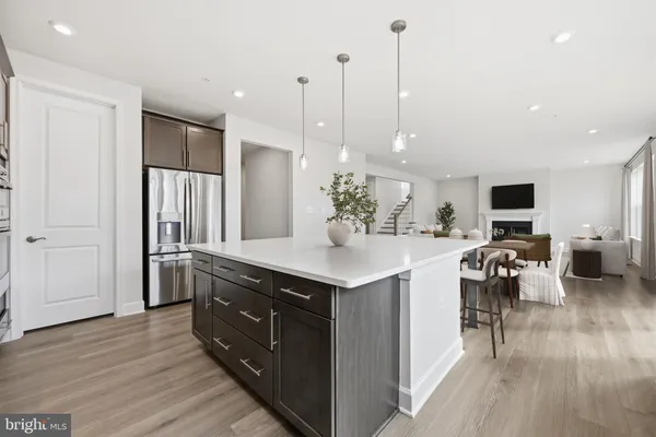 a kitchen with a sink a stove and chairs