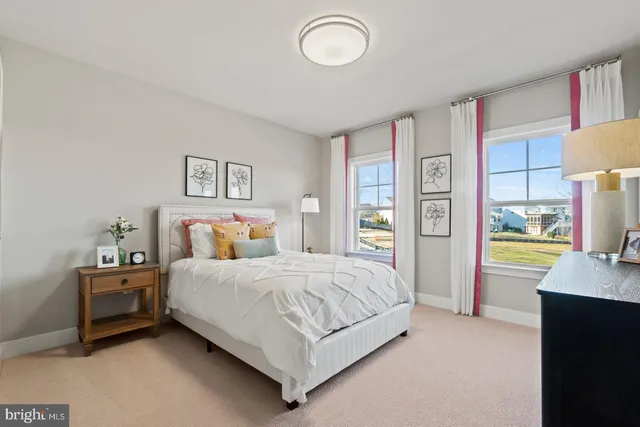 a bedroom with a bed and a view of living room