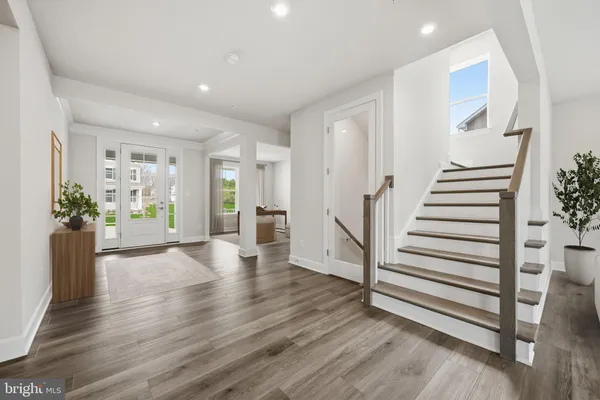 a view of a hallway with wooden floor and windows