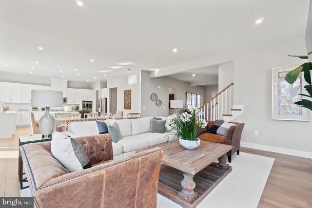 a living room with furniture kitchen and a table