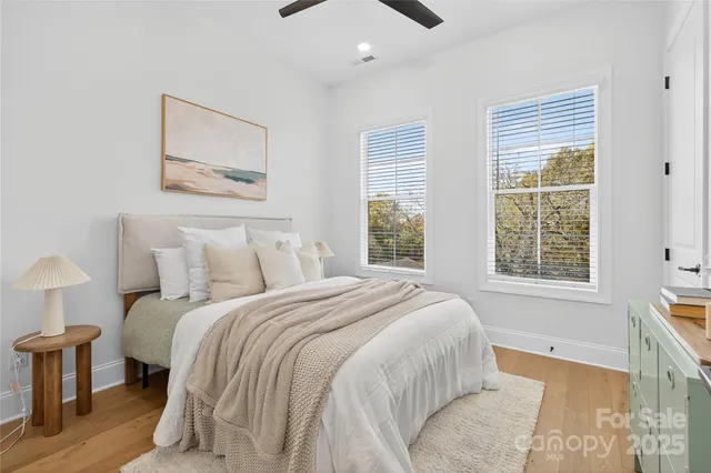 a bed sitting in a bedroom next to a window