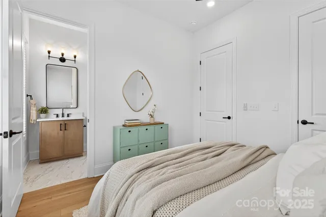 a bedroom with a bed and a mirror