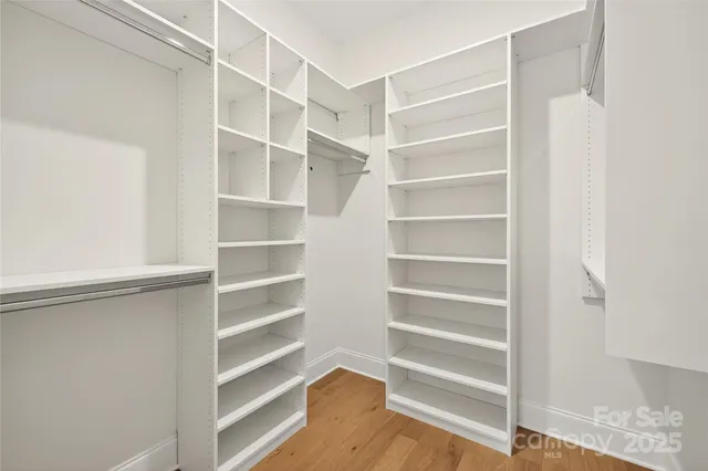 a spacious bathroom with a toilet sink and mirror