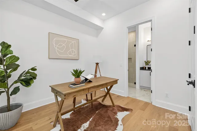 a view of a workspace room with wooden floor