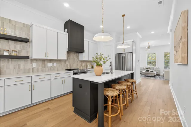 a kitchen with a sink a counter space and stainless steel appliances