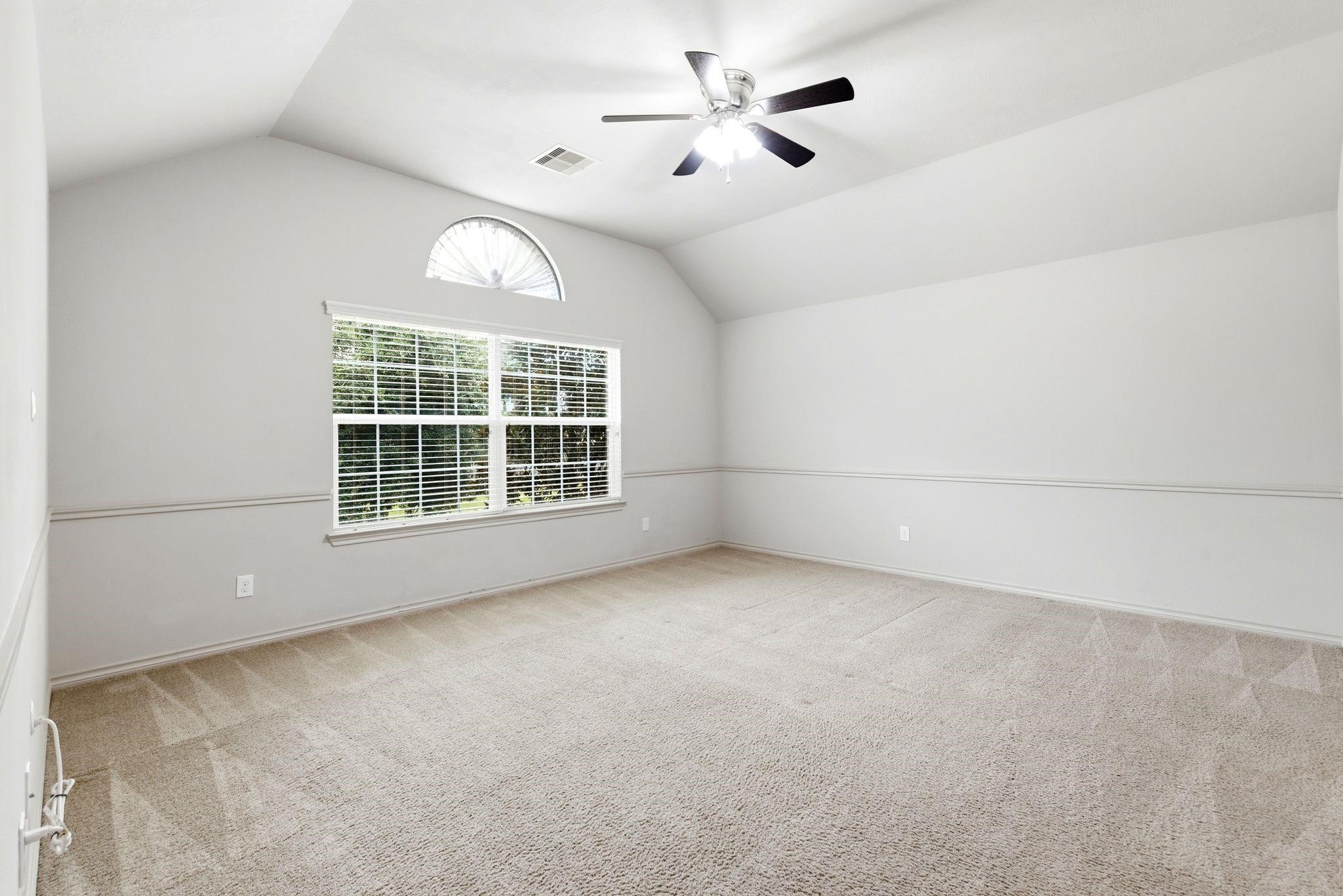 19903 Senterra Lakes Boulevard Spring, TX 77379 - Photo 42 of 50 Spacious additional primary bedroom upstairs that is a well-lit room with vaulted ceiling, perfect for versatile use.