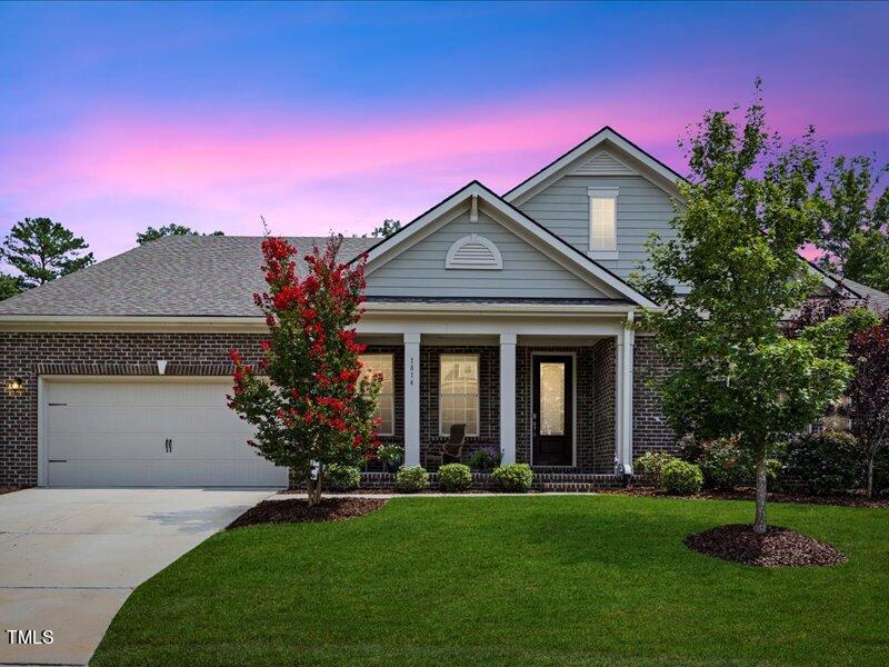 1814 Capstone Drive Durham, NC 27713 - Photo 1 of 32 a front view of a house with a yard and garage