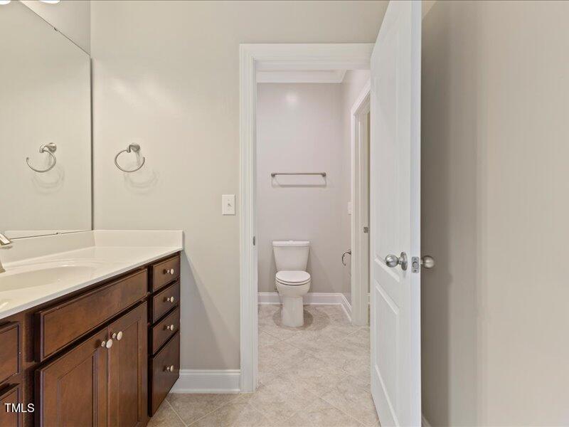1814 Capstone Drive Durham, NC 27713 - Photo 21 of 32 a bathroom with a granite countertop sink a toilet and shower