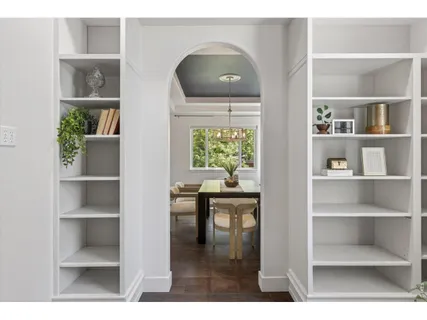 a living room with a wooden floor and a bookshelf