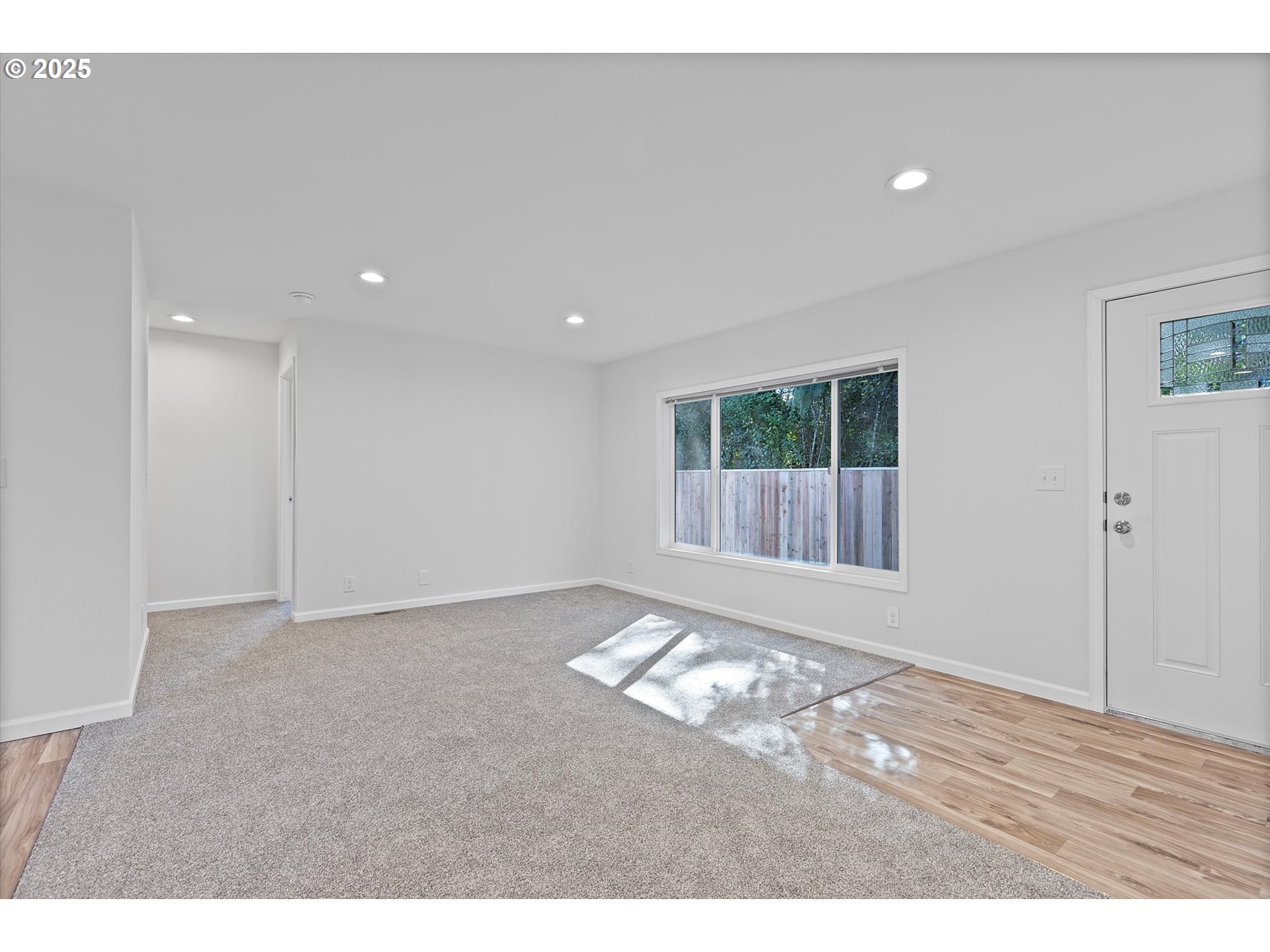 450 Southwest Juniper Road Estacada, OR 97023 - Photo 3 of 36 a view of an empty room with wooden floor and a window