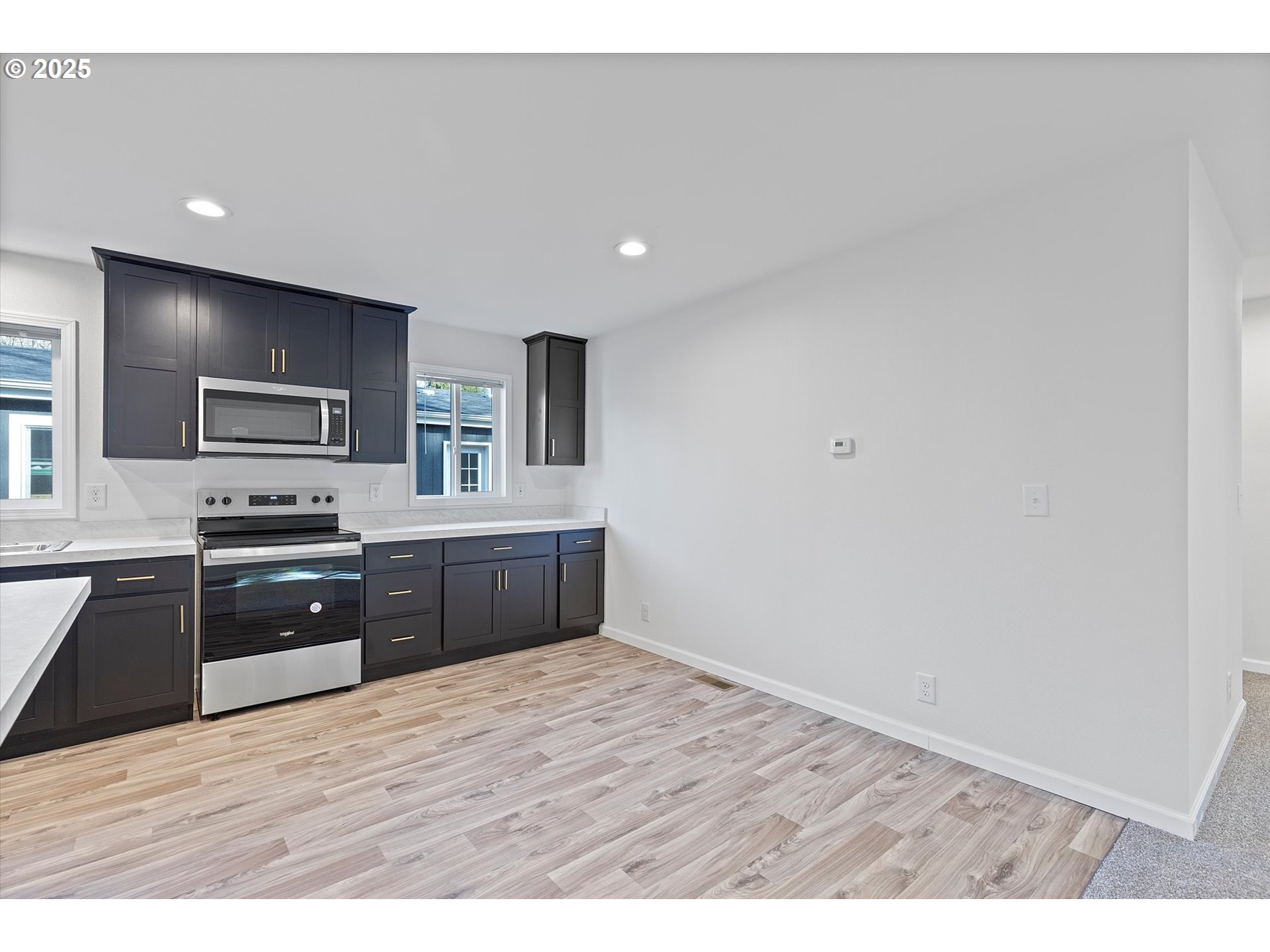 450 Southwest Juniper Road Estacada, OR 97023 - Photo 6 of 36 a large kitchen with wooden floors and wooden cabinets