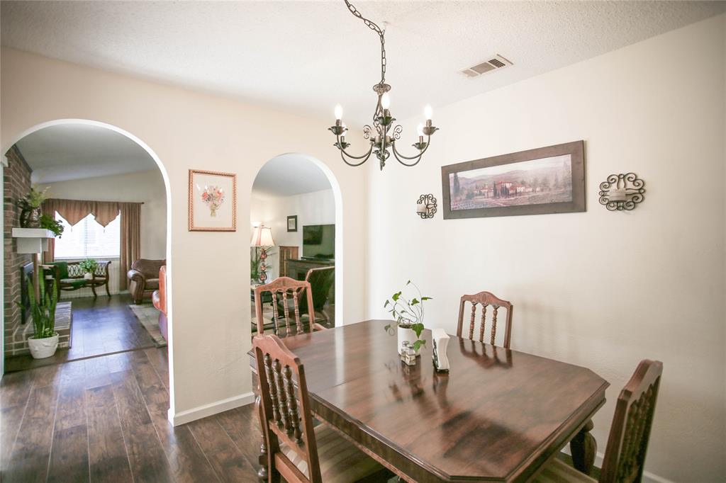 1720 Crystal Way Plano, TX 75074 - Photo 10 of 32 a view of a dining room with furniture wooden floor and chandelier