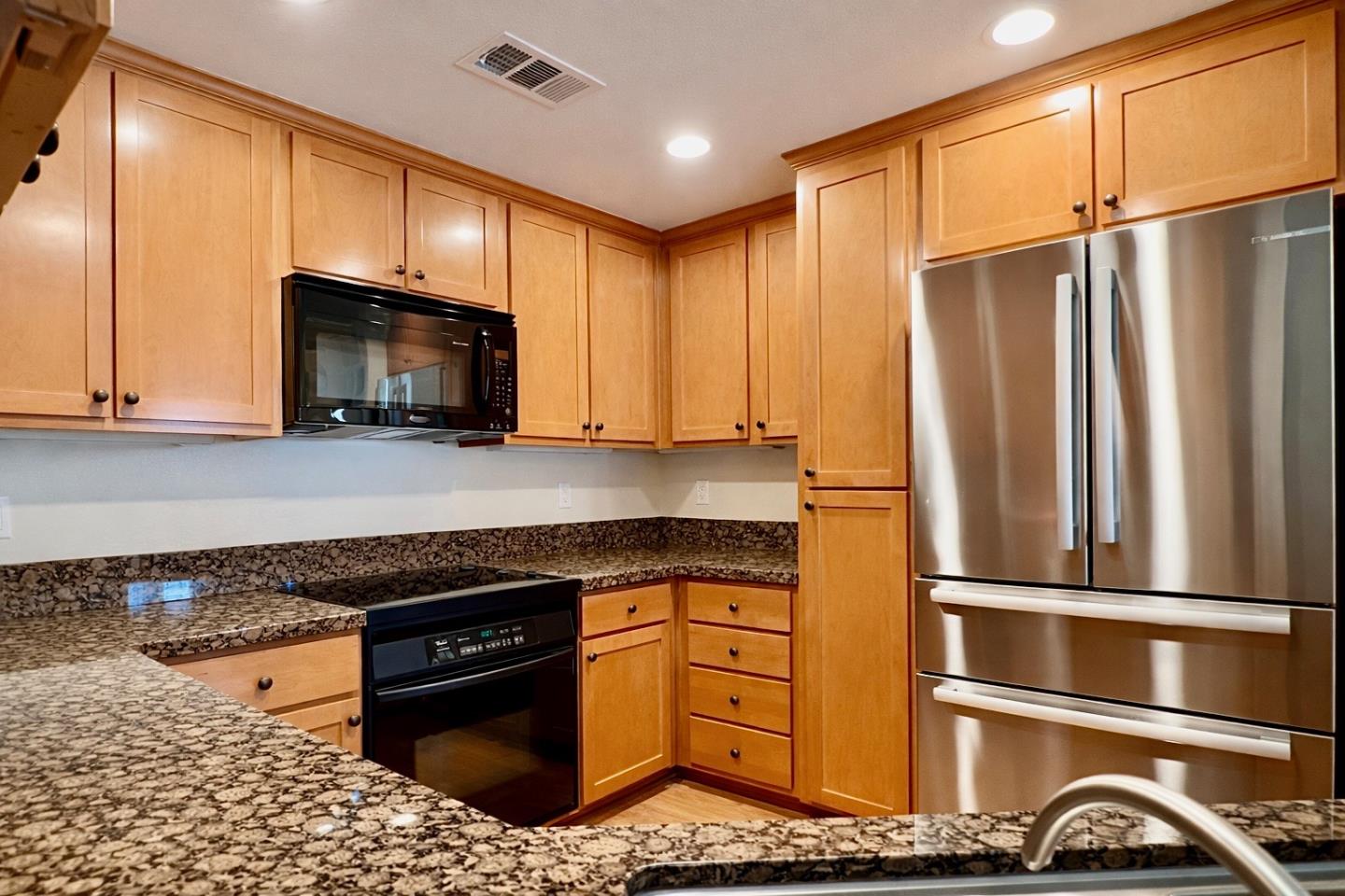 1310 Saddle Rack Street, Unit 347 San Jose, CA 95126 - Photo 8 of 42 a kitchen with stainless steel appliances granite countertop a refrigerator microwave and sink