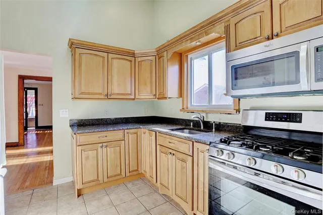 a kitchen with stainless steel appliances granite countertop a stove and a sink