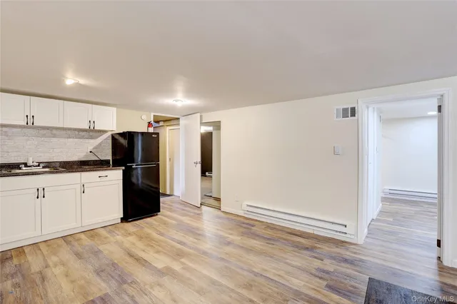 a kitchen with a refrigerator and a stove top oven
