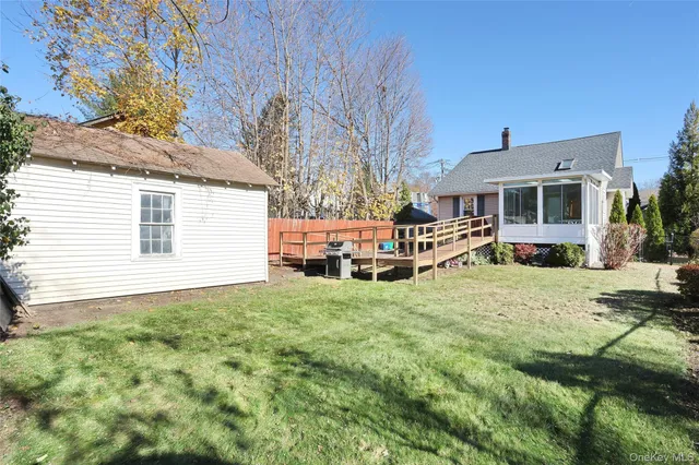 a backyard of a house with table and chairs