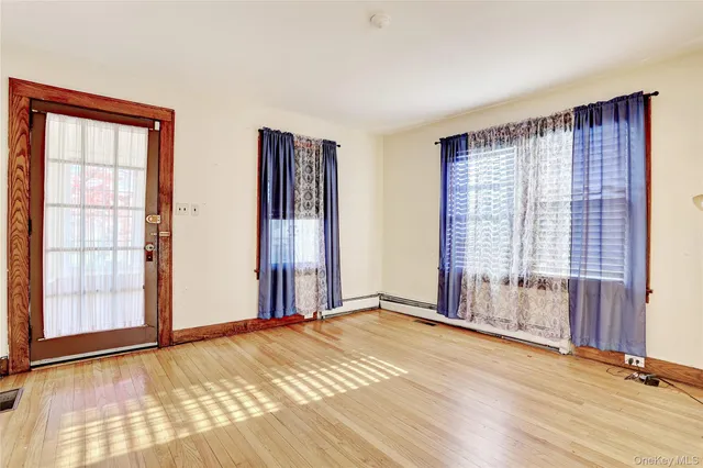 a view of an empty room with glass door