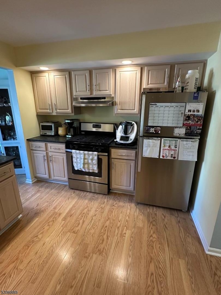 4D Avon Court Chatham, NJ 07928 - Photo 2 of 11 a kitchen with stainless steel appliances granite countertop a stove a sink and a refrigerator