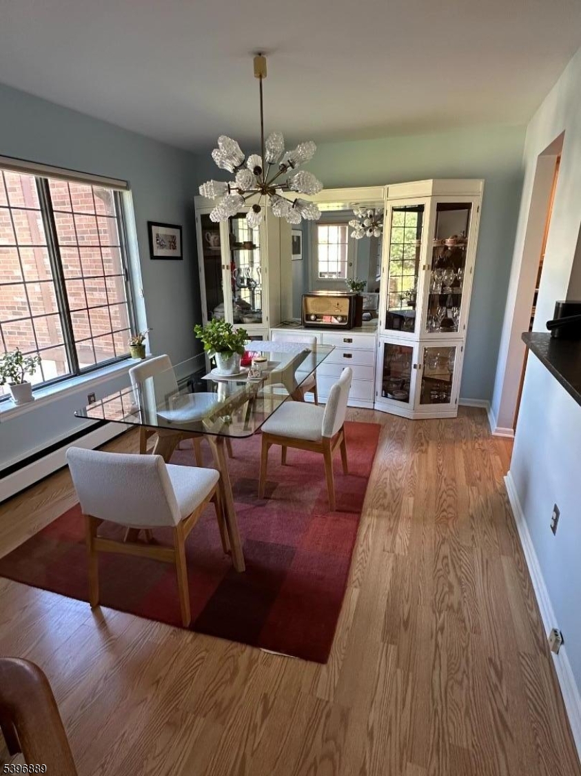 4D Avon Court Chatham, NJ 07928 - Photo 3 of 11 a living room with furniture or chandelier and a wooden floor