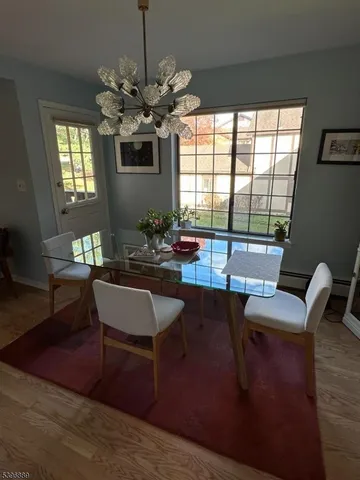 a living room with furniture a chandelier and a window