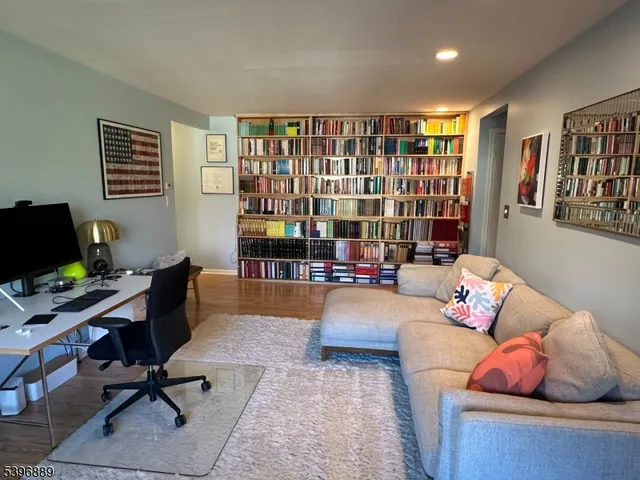 a living room with furniture and book shelf