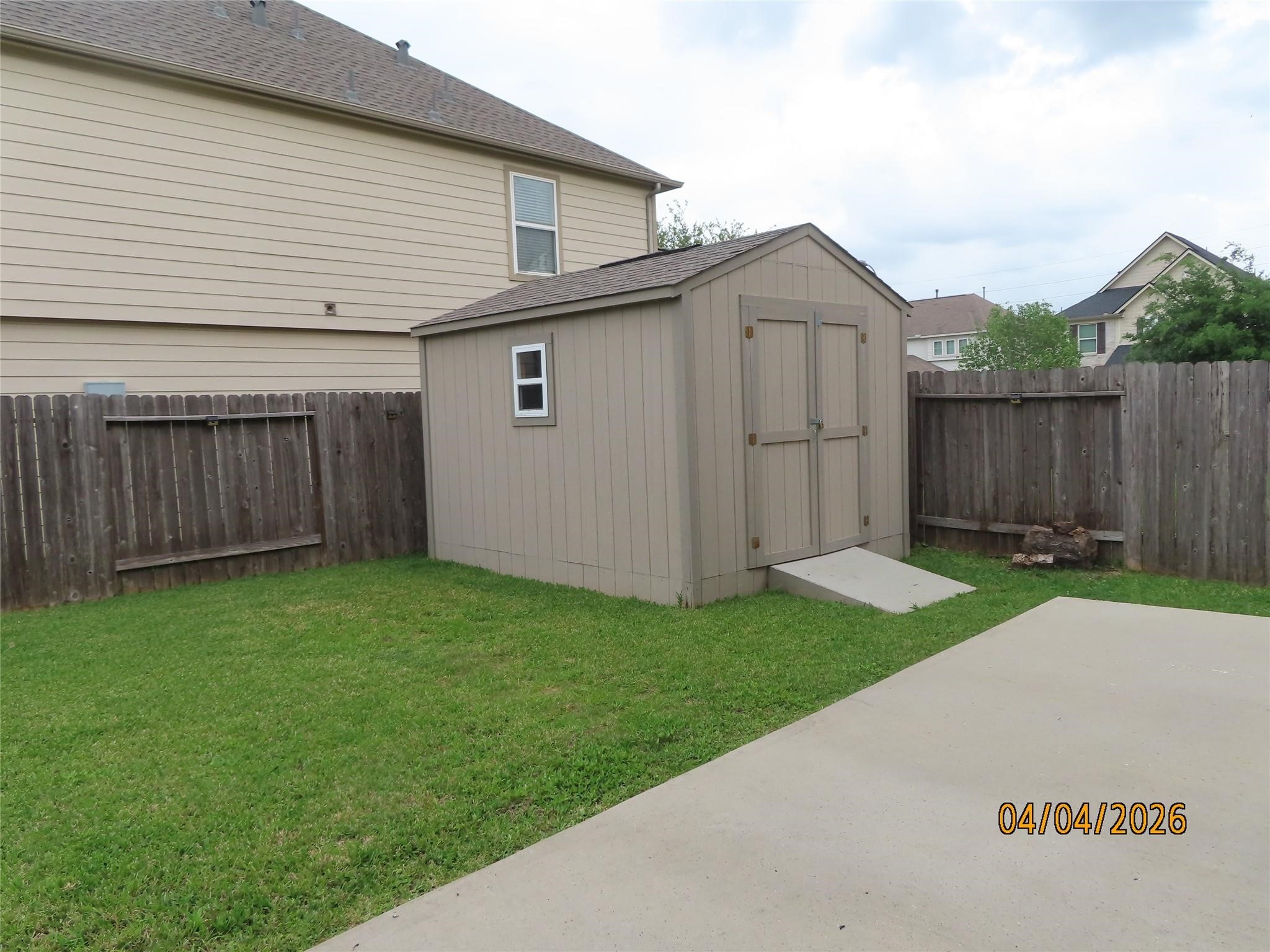 15631 South Fall Fern Circle Houston, TX 77044 - Photo 22 of 25 Spacious backyard with a storage shed, perfect for tools, equipment, and extra storage needs.