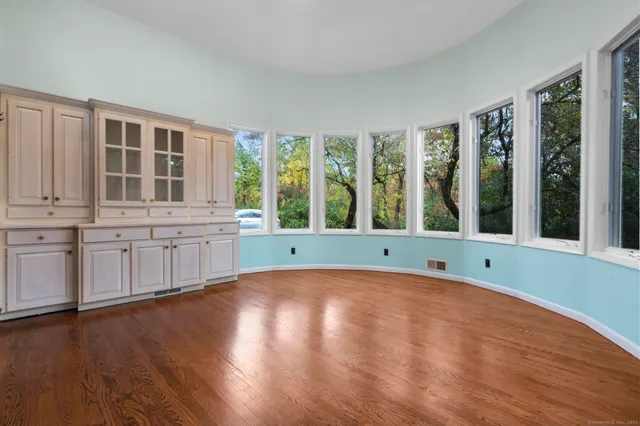 a view of a kitchen with wooden floor and a sink