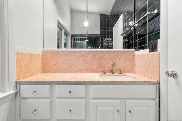a bathroom with a sink and a mirror