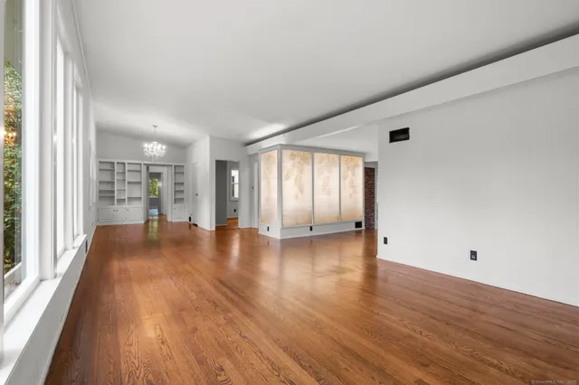 wooden floor in an empty room with a window