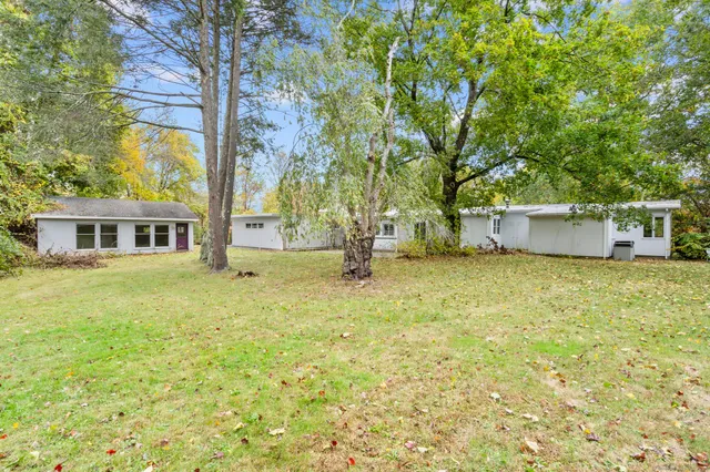 a front view of house with yard and trees