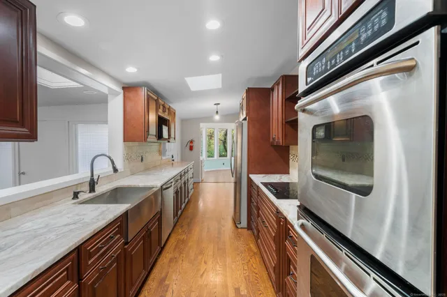 a kitchen with granite countertop a sink and cabinets