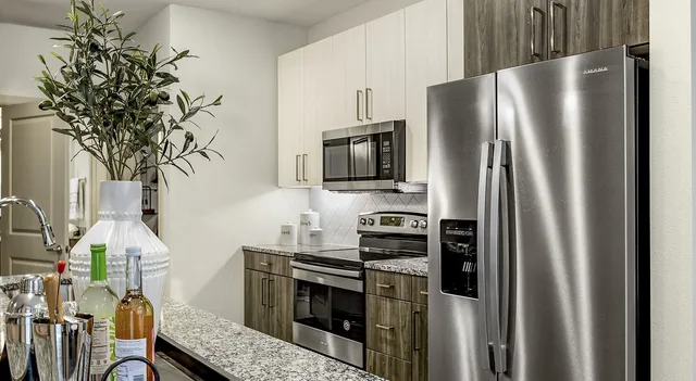 a kitchen with stainless steel appliances a refrigerator a stove and a sink