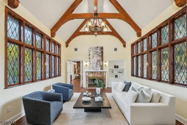 a living room with furniture fireplace and a large window
