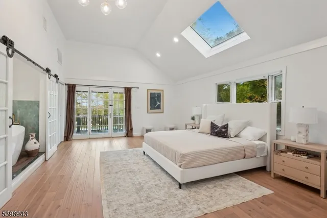 a bedroom with a large bed and a large window