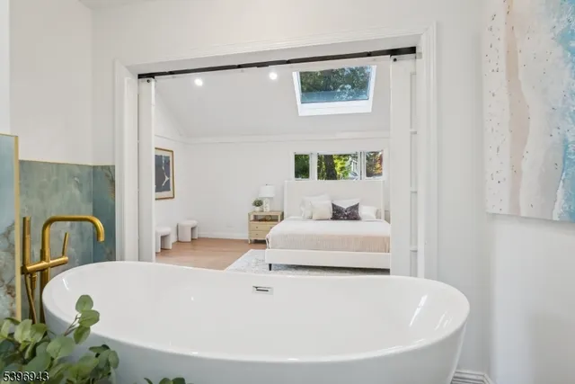 a spacious bathroom with a bathtub and window