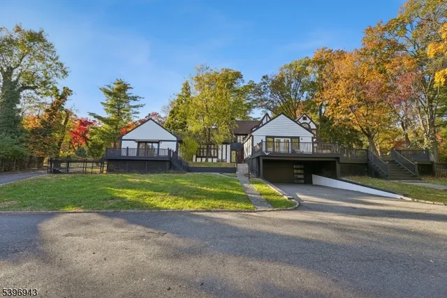 a house with green field in front of it