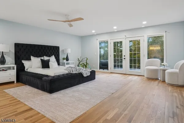 a bedroom with a large bed and a large window