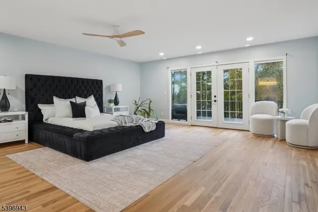 a bedroom with a large bed and a large window