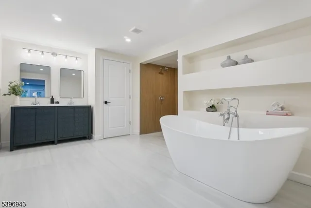 a white bath tub sitting in a en suite bathroom
