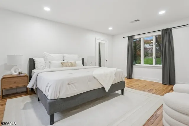 a bedroom with a bed and a large window