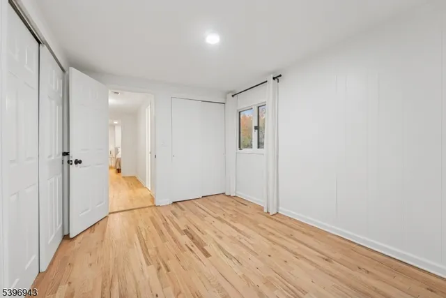 a view of a big room with wooden floor and windows