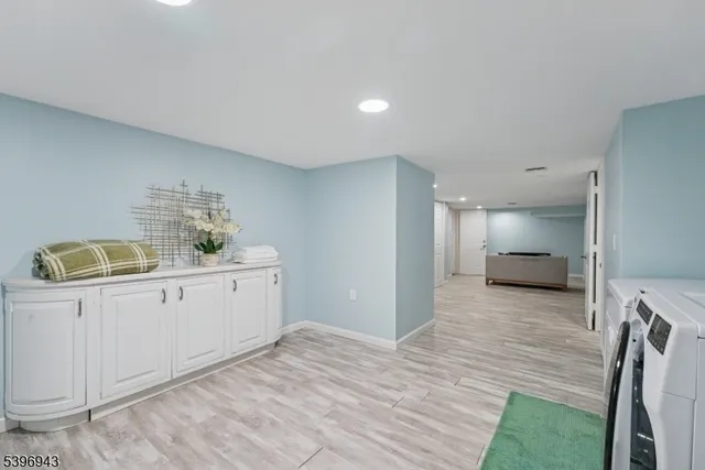 a kitchen with a sink cabinets and wooden floor