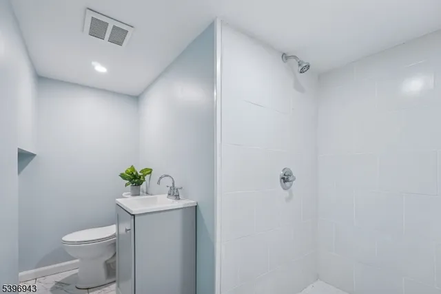 a white toilet sitting next to a bathroom sink