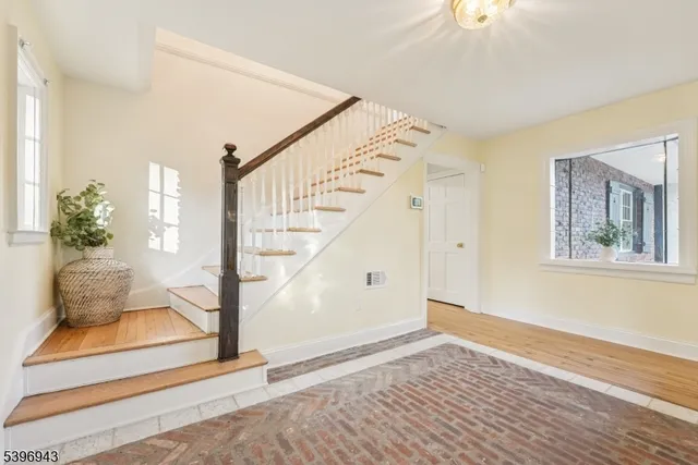 a view of entryway and hall with wooden floor