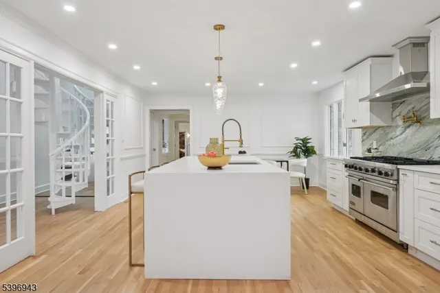 a kitchen with stainless steel appliances a stove a sink a refrigerator and a refrigerator