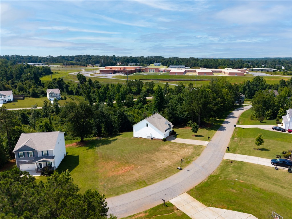 768 Rocky Ridge Circle Seneca, SC 29678 - Photo 27 of 30 An aerial perspective reveals a serene neighborhood nestled among lush woodlands, with a distant school providing convenience.
