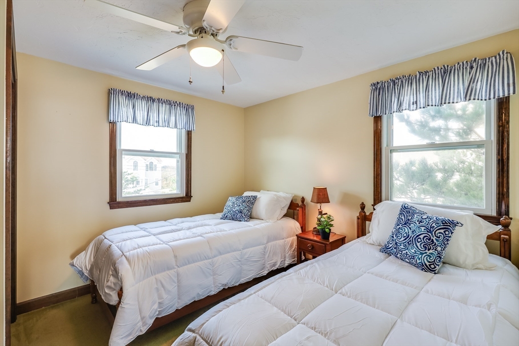 275 Phillips Road Sandwich, MA 02563 - Photo 22 of 40 a bedroom with two beds and a large window